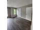 Bedroom with hardwood floors, neutral walls, three windows, and two doors at 3336 Waldrop Trl, Decatur, GA 30034