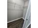 Bright walk-in closet with wire shelving, modern floors, and neutral colored walls at 3336 Waldrop Trl, Decatur, GA 30034