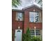 Charming brick exterior with a crisp white door, shuttered windows, and lush landscaping at 3336 Waldrop Trl, Decatur, GA 30034