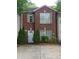 Charming red brick home featuring a light blue front door, green shrubbery and well-kept landscaping at 3336 Waldrop Trl, Decatur, GA 30034