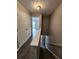 Hallway with hardwood floors and access to multiple rooms, featuring neutral paint tones and a stairwell to another level at 3336 Waldrop Trl, Decatur, GA 30034