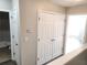 Hallway with closet doors and a view into the bathroom area featuring a bathtub at 3336 Waldrop Trl, Decatur, GA 30034