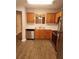 Well-equipped kitchen featuring wood cabinetry, white countertops, and stainless steel appliances for efficient cooking at 3336 Waldrop Trl, Decatur, GA 30034