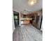 Open kitchen with vinyl floors, wood cabinets, and stainless steel appliances at 3336 Waldrop Trl, Decatur, GA 30034