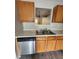 Kitchen sink and cabinets with light countertops and stainless steel dishwasher at 3336 Waldrop Trl, Decatur, GA 30034