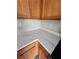 Close up of kitchen countertop with a marble-look countertop, wood cabinets, and stainless appliances at 3336 Waldrop Trl, Decatur, GA 30034