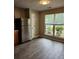 Eat-in kitchen area with luxury vinyl plank flooring, natural light, and stainless steel refrigerator at 3336 Waldrop Trl, Decatur, GA 30034
