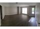 Bright and airy living room featuring hardwood floors, neutral paint, and large windows at 3336 Waldrop Trl, Decatur, GA 30034