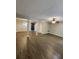 Open-concept living room with wood-look flooring, ceiling fan, and open access to other rooms at 3336 Waldrop Trl, Decatur, GA 30034
