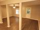 Expansive, column-supported living space with wood flooring, fan, and a door for easy outdoor access at 3336 Waldrop Trl, Decatur, GA 30034