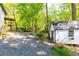 Idyllic backyard features a utility shed, gravel parking area, fire pit, and tiered landscaping at 4175 Valley Trail Se Dr, Atlanta, GA 30339