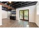 Finished basement featuring exposed ceiling, wood-look floors, and walkout access to the backyard at 4175 Valley Trail Se Dr, Atlanta, GA 30339