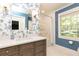 Stylish bathroom featuring floral wallpaper, a soaking tub, and a window overlooking the lush greenery at 4175 Valley Trail Se Dr, Atlanta, GA 30339