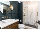 Modern bathroom with marble walk-in shower, vessel sink with gold fixtures, and dark accent wall at 4175 Valley Trail Se Dr, Atlanta, GA 30339