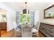 Cozy dining room with stylish lighting, hardwood floors, views of the landscaped outdoors, and neutral colors at 4175 Valley Trail Se Dr, Atlanta, GA 30339