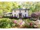 Charming brick home featuring a manicured front yard with lush landscaping and a symmetrical facade at 4175 Valley Trail Se Dr, Atlanta, GA 30339