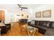Open concept living room with leather couch, hardwood floors, and view into a modern kitchen with island seating at 4175 Valley Trail Se Dr, Atlanta, GA 30339