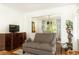 Comfortable seating area with a couch and a fireplace with a wreath, with wood floors and plenty of natural light at 4175 Valley Trail Se Dr, Atlanta, GA 30339