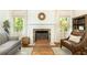 Cozy living room featuring a fireplace with decorative screen, comfortable seating, and natural light at 4175 Valley Trail Se Dr, Atlanta, GA 30339