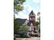 Charming architecture featuring a clock tower, dining patios, and street views at 4175 Valley Trail Se Dr, Atlanta, GA 30339