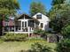 Backyard featuring deck, patio, screened in porch, lush lawn, and mature landscaping at 2029 Tuxedo Ne Ave, Atlanta, GA 30307
