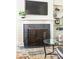 Close-up of a stylish fireplace with a decorative screen, flanked by custom-built shelving at 2029 Tuxedo Ne Ave, Atlanta, GA 30307