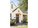 Attractive brick home with well-maintained landscaping, arched entryway, and dark trimmed windows at 2029 Tuxedo Ne Ave, Atlanta, GA 30307