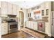 Well-lit kitchen with stainless steel appliances, hardwood floors, and plenty of cabinet space at 2029 Tuxedo Ne Ave, Atlanta, GA 30307