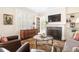 Sunlit living room featuring shuttered windows, a fireplace, and a neutral color palette at 2029 Tuxedo Ne Ave, Atlanta, GA 30307