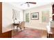 This home office features a ceiling fan, natural light, and a decorative vintage rug at 2029 Tuxedo Ne Ave, Atlanta, GA 30307