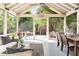 Relaxing screened patio with dining table, wicker sofa and open door to outdoor deck at 2029 Tuxedo Ne Ave, Atlanta, GA 30307