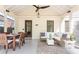 Inviting screened-in patio with wicker furniture, dining table, ceiling fan and view of yard at 2029 Tuxedo Ne Ave, Atlanta, GA 30307
