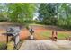 View of backyard featuring a grill, chiminea, and a two-tiered retaining wall at 2602 White Aster Ln, Dacula, GA 30019