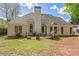 Backyard with a patio, grill, and lawn, surrounded by trees and lush greenery at 2602 White Aster Ln, Dacula, GA 30019