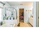 This bathroom includes a shower with glass door, a bathtub, and is nicely illuminated at 2602 White Aster Ln, Dacula, GA 30019