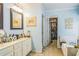 This bathroom features a double vanity, bathtub, and a well-organized walk-in closet at 2602 White Aster Ln, Dacula, GA 30019