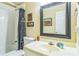 Bathroom showcasing a vanity with sink, a mirror, and a shower-tub combination at 2602 White Aster Ln, Dacula, GA 30019