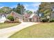 Lovely brick home featuring a well-maintained front yard and a long driveway on a sunny day at 2602 White Aster Ln, Dacula, GA 30019