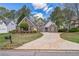 Beautiful brick home showcasing a well-maintained front yard and a long driveway at 2602 White Aster Ln, Dacula, GA 30019