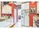 Spacious kitchen featuring ample white cabinetry, stainless steel appliances, and a view of the dining area at 2602 White Aster Ln, Dacula, GA 30019