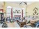 Comfortable living room with neutral walls, fireplace, ceiling fan, and multiple seating options at 2602 White Aster Ln, Dacula, GA 30019