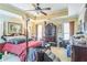 Spacious main bedroom with tray ceilings, a four-poster bed, and ample closet space at 2602 White Aster Ln, Dacula, GA 30019