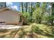 View of the home's backyard, featuring a wooden deck that is surrounded by trees and lawn at 2650 Gwendon Ct, Decatur, GA 30034