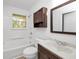 Clean bathroom with a wood vanity, standard fixtures, and window for natural light at 2650 Gwendon Ct, Decatur, GA 30034