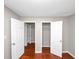 Bedroom features a closet, access to another room, neutral paint, and wood flooring at 2650 Gwendon Ct, Decatur, GA 30034