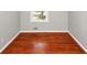 A cozy bedroom featuring wood flooring, crisp white trim, and a bright window view at 2650 Gwendon Ct, Decatur, GA 30034