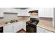 White cabinets, black appliances, and neutral countertops in this compact but efficient kitchen at 2650 Gwendon Ct, Decatur, GA 30034