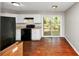 Functional kitchen features white cabinets, black appliances, and a sliding door to the outside at 2650 Gwendon Ct, Decatur, GA 30034