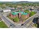 Aerial shot of a brick building with a green roof, surrounded by streets and trees at 1095 Lanier Pl, Cumming, GA 30041