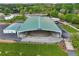 Expansive aerial shot of a covered outdoor arena, showcasing its ample seating and surrounding landscape at 1095 Lanier Pl, Cumming, GA 30041